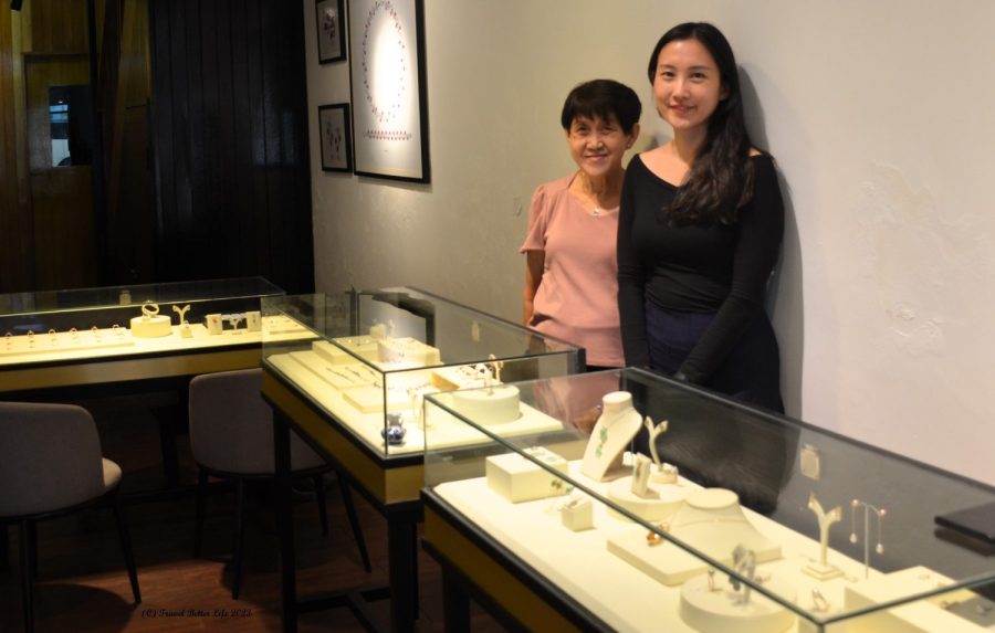 Image of Dorothy Jen Atelier and her mother standing behind a jewellery display cabinet