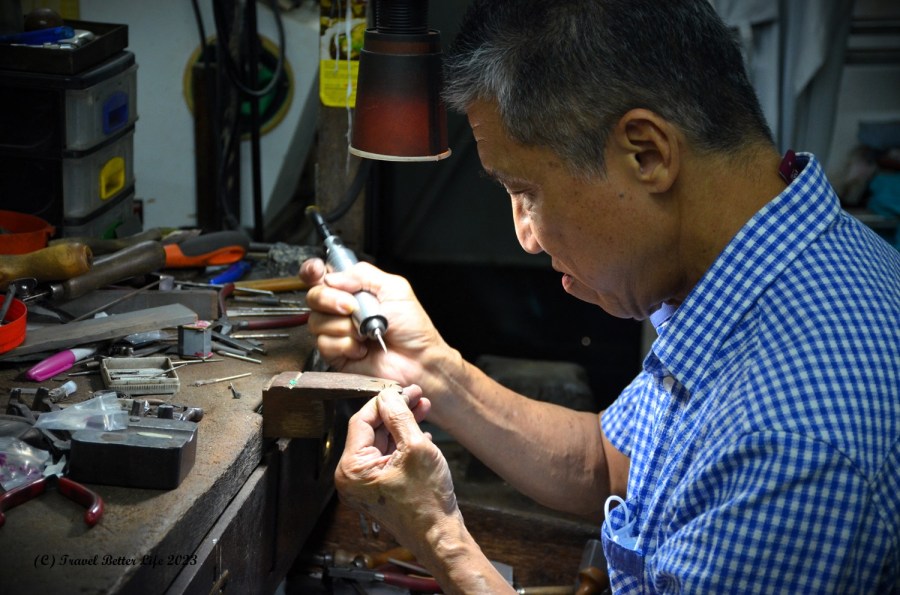 Image of silversmith working on jewellery 