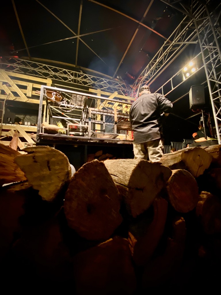 Image of person cooking in outdoor pizza oven during Vivid Sydney 2024 Fire Kitchen