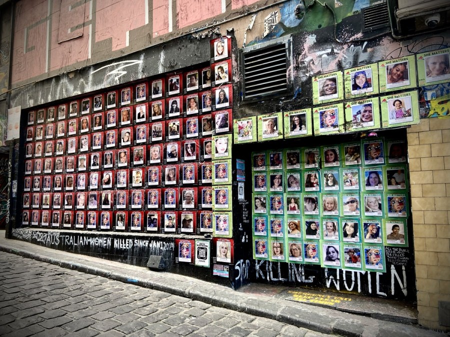 photo of a wall in Hosier Lane Melbourne, covered in posters of victims of violence against women.