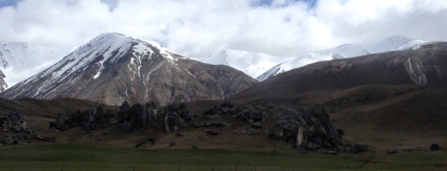 Photo of NZ Valley and snow capped mountains looking like the plains of Mordor